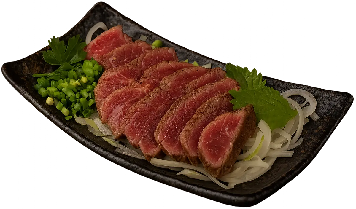 Full view of beef tataki slices on a black ceramic plate with garnishes, set against a dark background with no elements cut off.